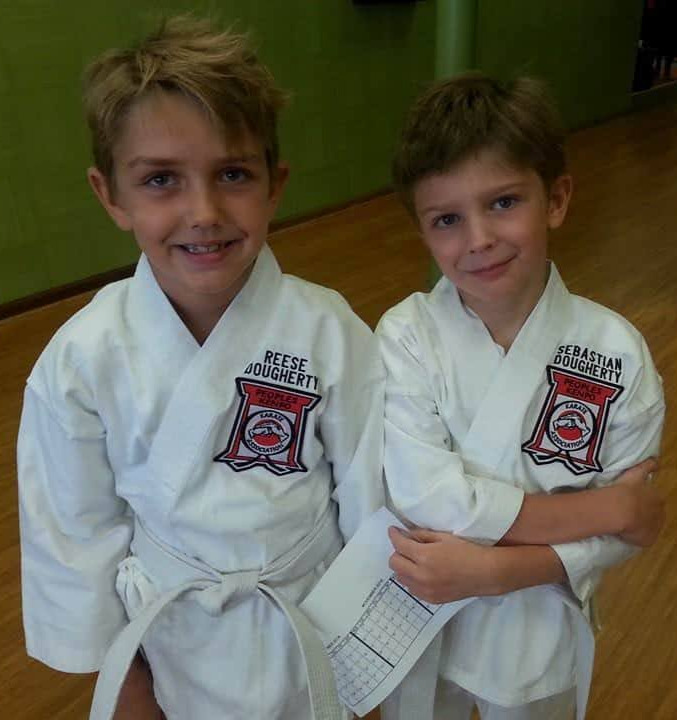 Reese and Sebastian Dougherty in white gis — the boys who inspired Rhyno's PKKA